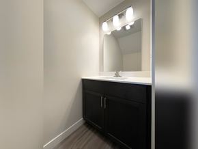 Sioux Center apartment for rent - A bathroom vanity with a mirror and lights above it.