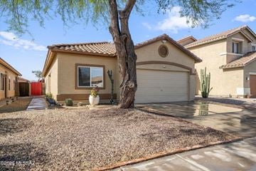 Tucson house for rent - A house with a red door and a tree in front.