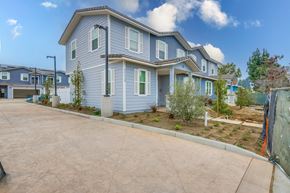 Santa Ana apartment for rent - A blue house with a driveway in front.