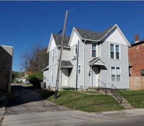 Lima house for rent - A two-story house with a grey siding exterior and a white door.