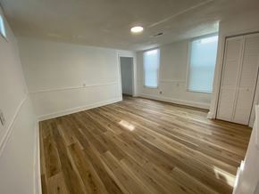 Louisville house for rent - A room with wooden flooring and white walls.