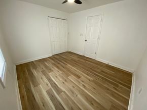 Louisville house for rent - A room with wooden flooring and two white doors.