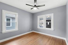 Hammond house for rent - A room with a ceiling fan and two windows.