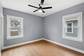 Hammond house for rent - A room with a ceiling fan and two windows.