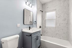 Hammond house for rent - A bathroom with a sink, toilet, and bathtub.