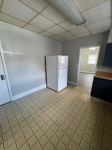 Findlay apartment for rent - A kitchen with a white fridge and a tiled floor.