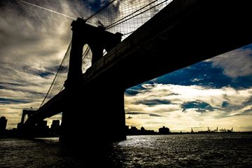 Brooklyn apartment for rent - A bridge silhouette against a sunset sky.