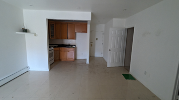 Queens apartment for rent - A kitchen with white walls and a tiled floor.