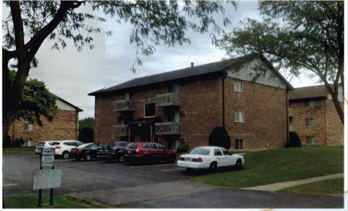 Westmont apartment for rent - A parking lot with cars and a building in the background.