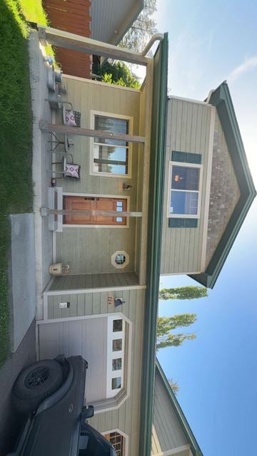 Whitefish apartment for rent - A house with a green roof and a white wall with a window and a door.