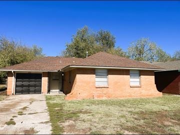 Oklahoma City house for rent - A house with a garage and a driveway.