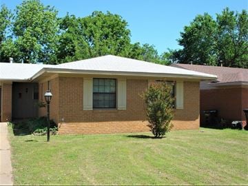 Oklahoma City house for rent - A house with a white roof and a brick exterior.