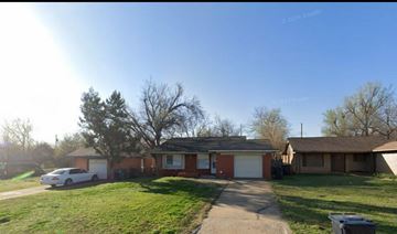 Oklahoma City house for rent - A house with a car parked in front.