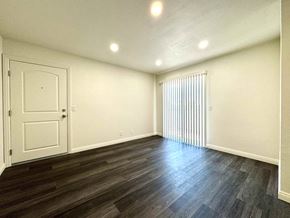 Anaheim apartment for rent - A room with a white door and a window with blinds.