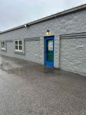 Erlanger house for rent - A grey building with a blue door and windows.