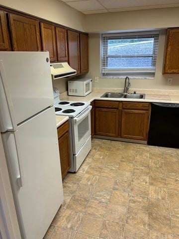 Erlanger house for rent - A kitchen with a white refrigerator, a stove, a microwave, and a sink.