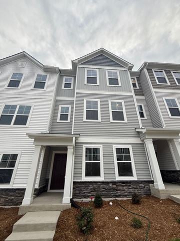 Morrisville house for rent - A grey and white two story house with a brown door and windows.
