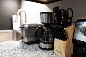 Huntsville apartment for rent - A kitchen counter with a toaster, knives, and a coffee maker.