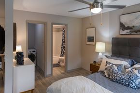 Huntsville apartment for rent - A bedroom with a bed, nightstand, and a ceiling fan.