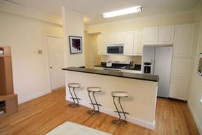 Cambridge apartment for rent - a kitchen with a bar with three stools