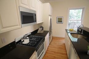 Cambridge apartment for rent - a kitchen with a stove and a microwave