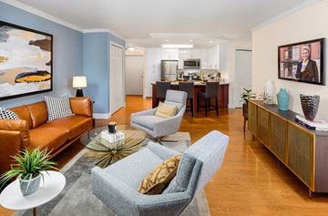 Framingham apartment for rent - a living room and kitchen with a couch and chairs