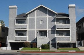 Van Nuys apartment for rent - A grey building with a cross on the window.