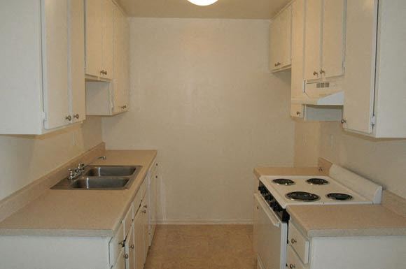 Van Nuys apartment for rent - A kitchen with white cabinets and a stove top oven.