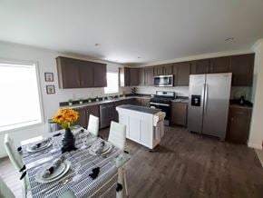 Trinidad apartment for rent - A kitchen with brown cabinets and a checkered tablecloth.