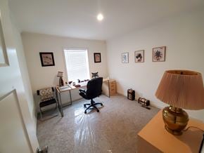 Trinidad apartment for rent - A room with a desk, chair, and pictures on the wall.