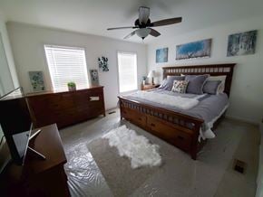 Trinidad apartment for rent - A bedroom with a bed, dresser, and ceiling fan.