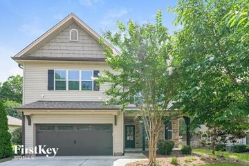 Winston Salem house for rent - A house with a garage and a tree in front.