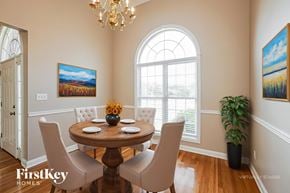 Clarksville house for rent - A dining room with a wooden table and chairs.
