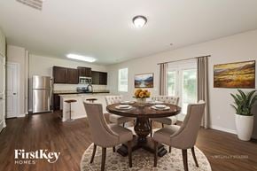 Gainesville house for rent - A dining room with a wooden table and chairs.