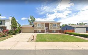 Aurora apartment for rent - A house with a brown roof and a white garage door.