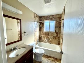 Aurora apartment for rent - A bathroom with a toilet, sink, and bathtub.