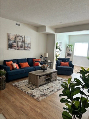 Boiling Springs apartment for rent - A living room with a blue couch, a grey coffee table, and a plant.