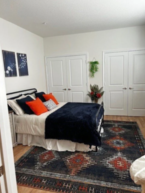 Boiling Springs apartment for rent - A bedroom with a bed, two doors, and a rug.
