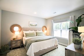 Little Rock house for rent - A bedroom with a large bed and two lamps on either side of the bed.