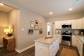 Little Rock house for rent - A kitchen with white cabinets and a granite countertop.