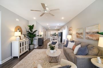 Little Rock house for rent - A well-lit, modern living room with a variety of furniture and decor.