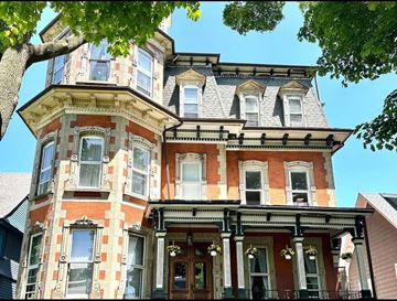 Buffalo apartment for rent - A Victorian style house with a tower and bay windows.