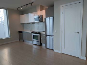 Vancouver apartment for rent - A kitchen with white cabinets and stainless steel appliances.