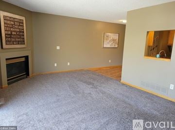 Farmington house for rent - A living room with a fireplace and a painting on the wall.