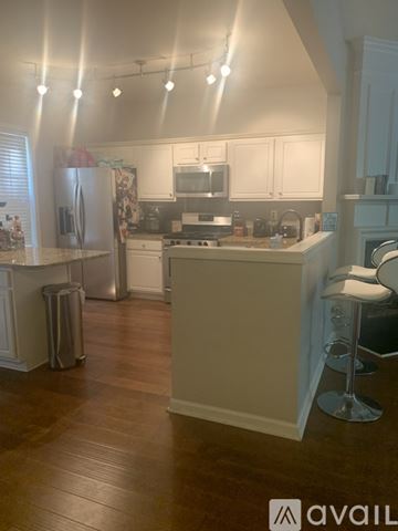 Atlanta house for rent - A kitchen with white cabinets and a wooden floor.