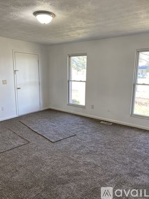 Williamsburg townhouse for rent - A room with a carpeted floor, a door, and two windows.
