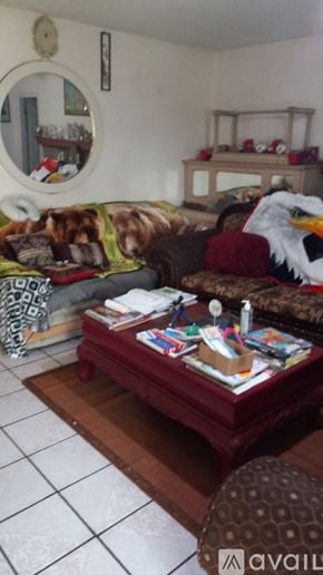 Riverside apartment for rent - A living room with a couch, a coffee table, and a mirror on the wall.