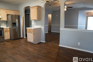 San Antonio house for rent - A kitchen with wooden cabinets and stainless steel appliances.