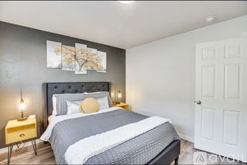 Grand Junction apartment for rent - A bedroom with a large bed and a painting on the wall.