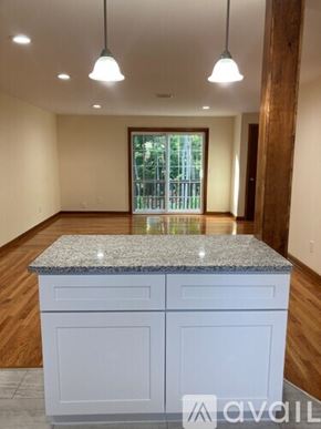 Northford apartment for rent - A spacious room with wooden floors and a staircase on the left side.